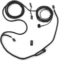 Multi-branch black wiring harness with protective corrugated loom, several electrical connectors, coiled cable sections, and a small rectangular rocker switch.