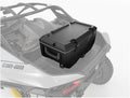 Large black hard-sided cooler mounted on the rear cargo area of a Can-Am Maverick R, featuring a fitted lid, dual latches, and integrated carrying handle.