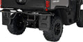 Black molded mud flaps shown installed behind the rear wheels of a Can-Am Defender. Each flap features raised Can-Am branding and a rugged factory-style design.
