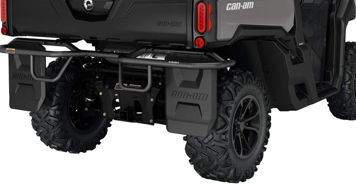 Black molded mud flaps shown installed behind the rear wheels of a Can-Am Defender. Each flap features raised Can-Am branding and a rugged factory-style design.