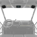 Overhead audio system installed beneath a Defender roof with two round speakers positioned at the outer corners and a central control unit above the windshield.
