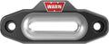 Black WARN winch rope guide with a smooth silver center opening, two recessed mounting holes, and red-and-white WARN branding.