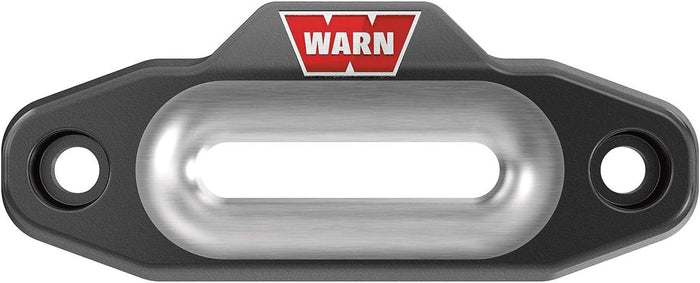 Black WARN winch rope guide with a smooth silver center opening, two recessed mounting holes, and red-and-white WARN branding.