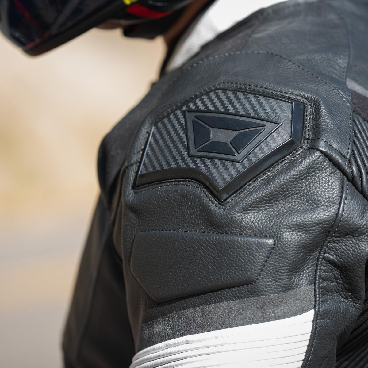 Black Cortech leather riding jacket with stretch panels and shoulder sliders designed for performance motorcycle riding.