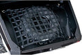 Black woven cargo net stretched across a Commander cargo box and secured at multiple points, holding a spare tire firmly in place.