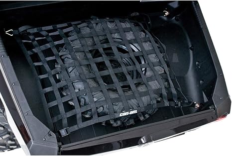 Black woven cargo net stretched across a Commander cargo box and secured at multiple points, holding a spare tire firmly in place.
